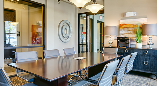 A conference room with a table and chairs for meeting needs. One of the topnotch services offered at Enclave at Box Hill.