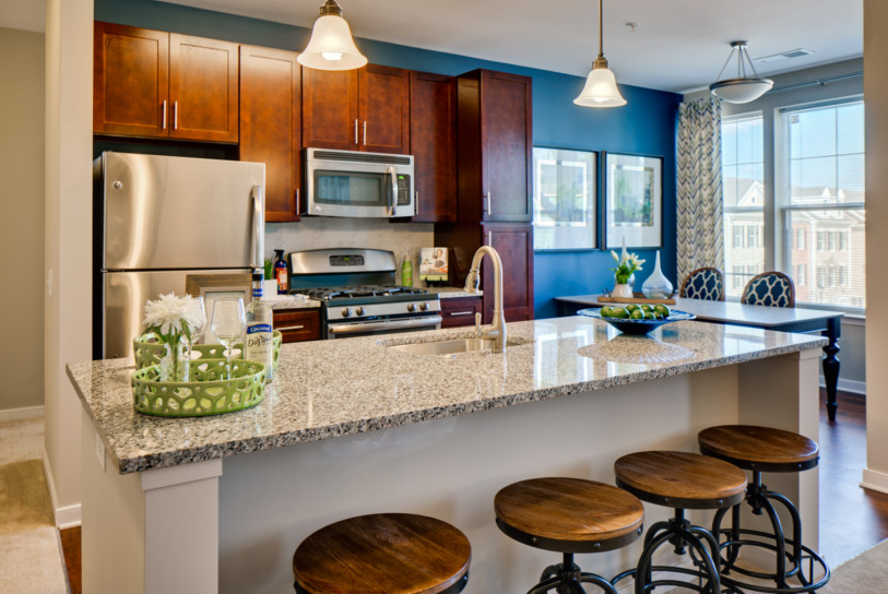Gourmet kitchens include gas ranges, granite countertops, kitchen islands, Shaker cabinets, backsplash tiles and GE ENERGY STAR stainless steel appliances.