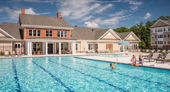 Picturesque apartments in Abingdon, Bel Air, and Aberdeen, MD with a group of people enjoying the pool.